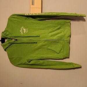 Small neon green Hollistet zip up hoodie with logo sewn on left arm